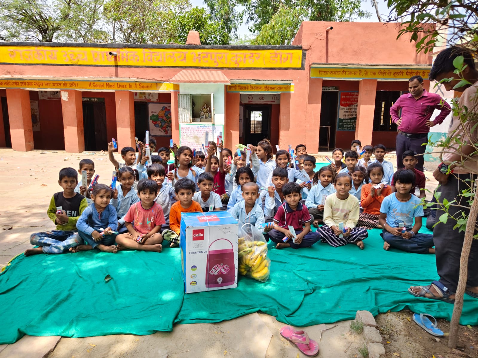 Children seated on new floor mats in their classroom